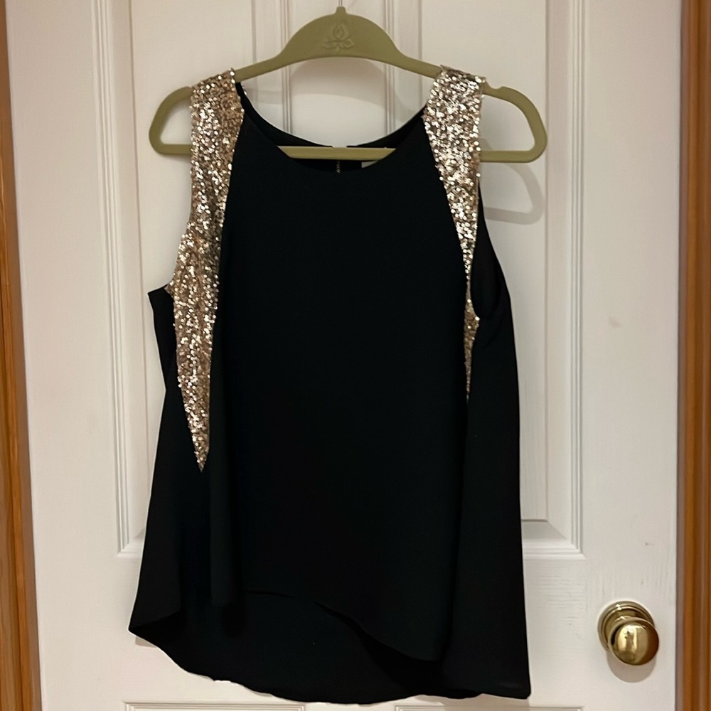 Black dressy sleeveless shirt. Gold sequined around sleeve area.